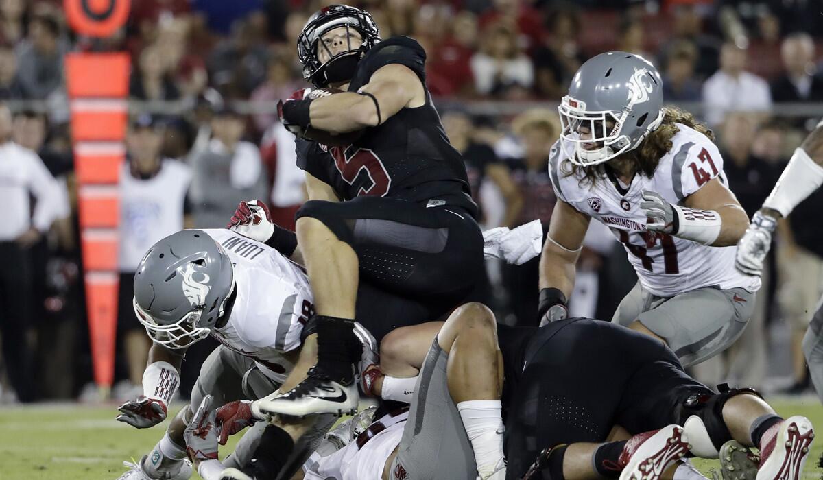 Stanford's Christian McCaffrey (5) is stopped by a group of Washington State defenders during the first half Saturday.