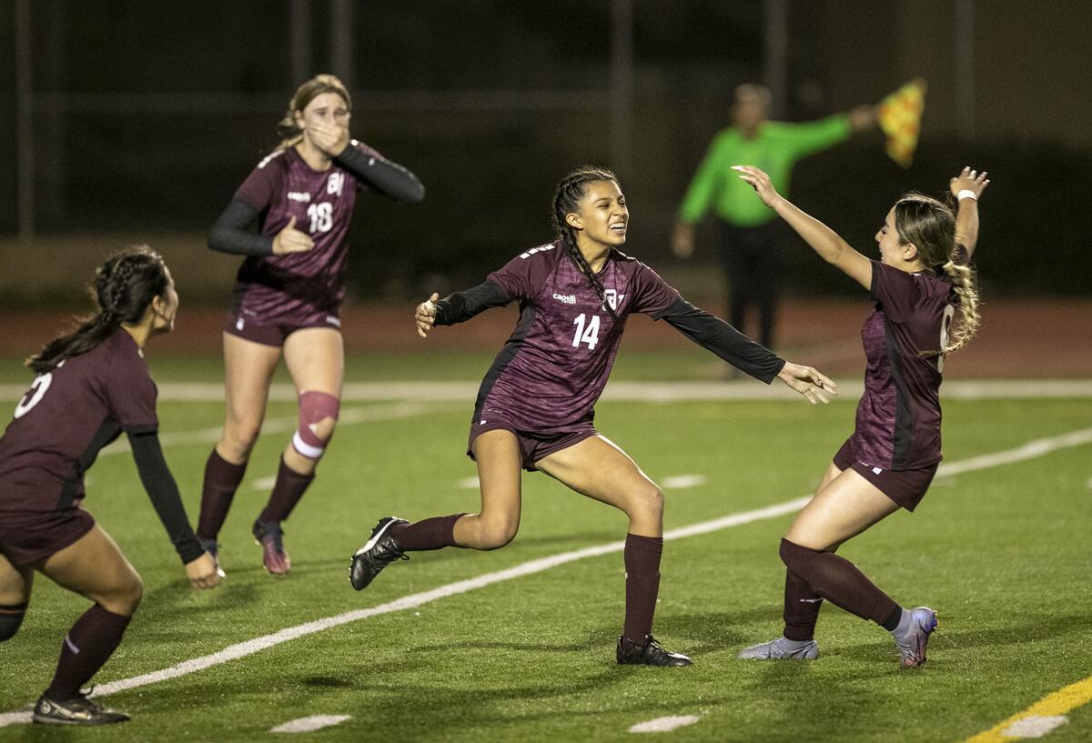 Ocean View's Isis Salazar, center, celebrates with Jizelle Ruiz, right, after Salazar scores a goal.