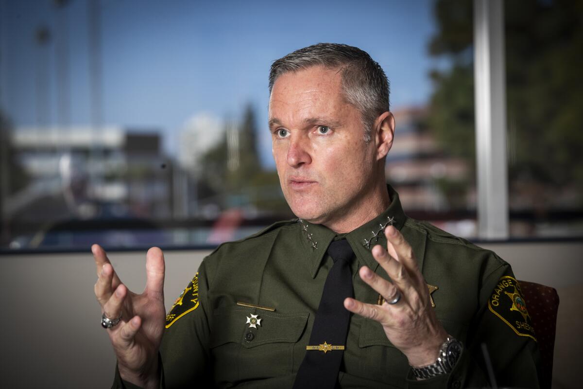 Orange County Sheriff Don Barnes talks in his office.