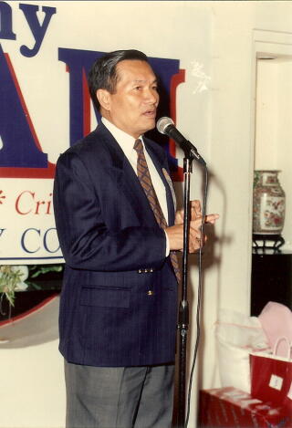 Tony Lam standing at a microphone