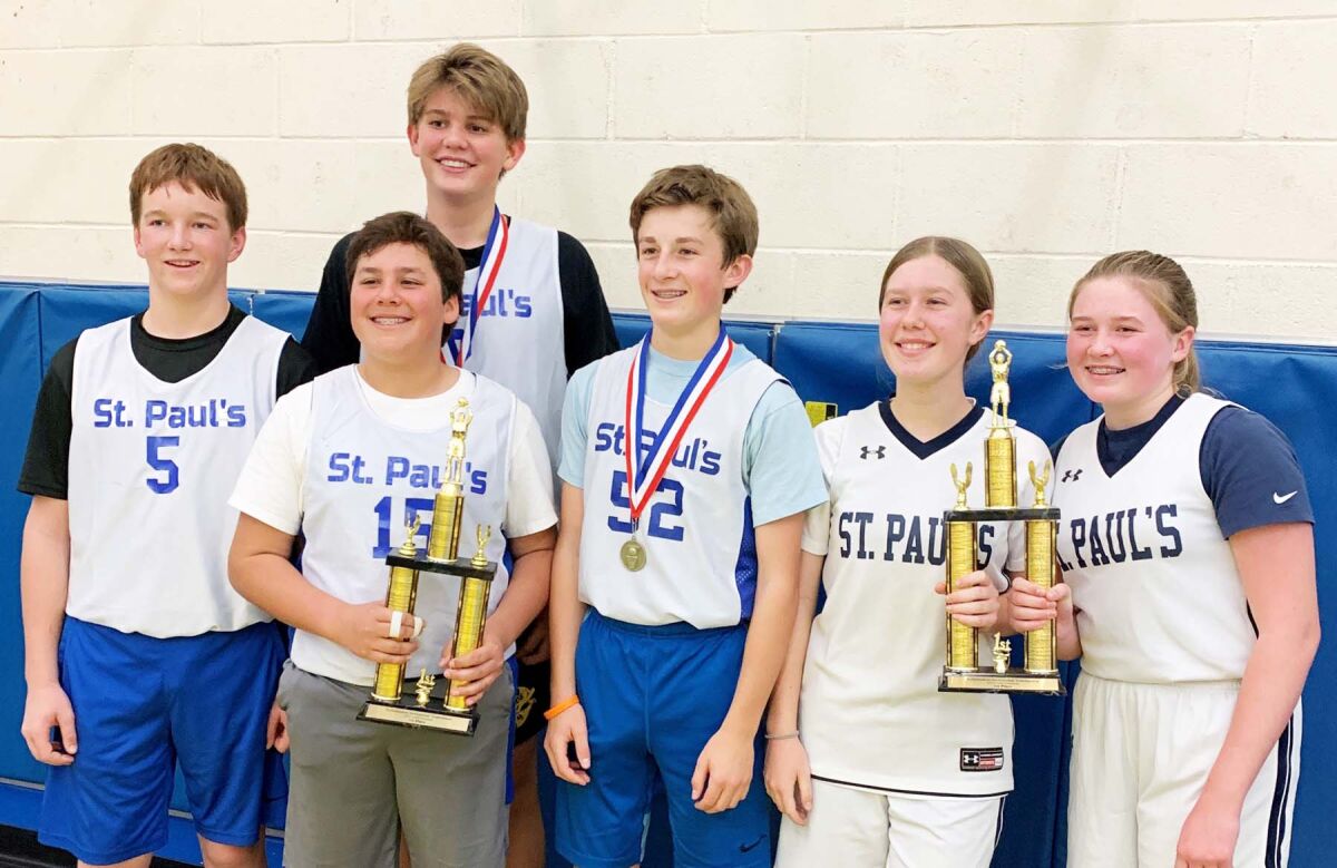 Members of St. Paul’s boys and girls basketball teams with their tournament championship trophies.