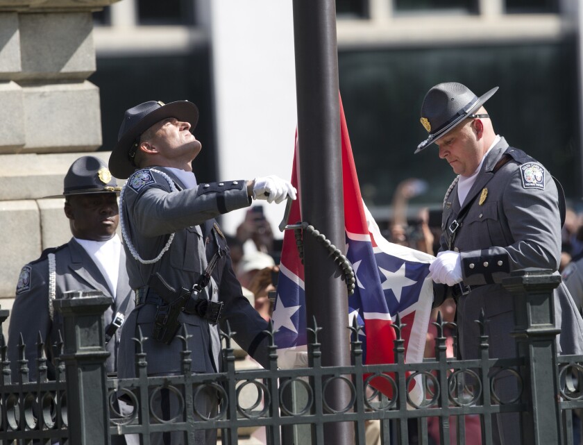 An honor guard from the South Carolina Highway Patrol removes the Confederate battle flag from the Capitol grounds.