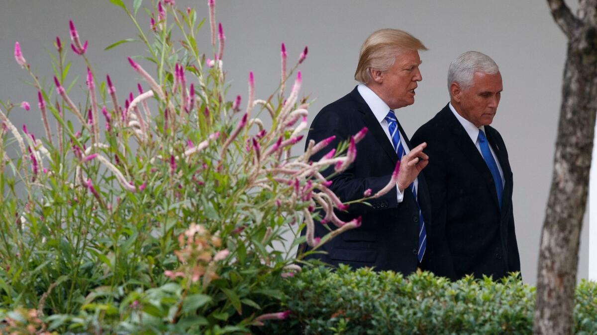 President Trump walks with Vice President Mike Pence at the White House on Sept. 6.
