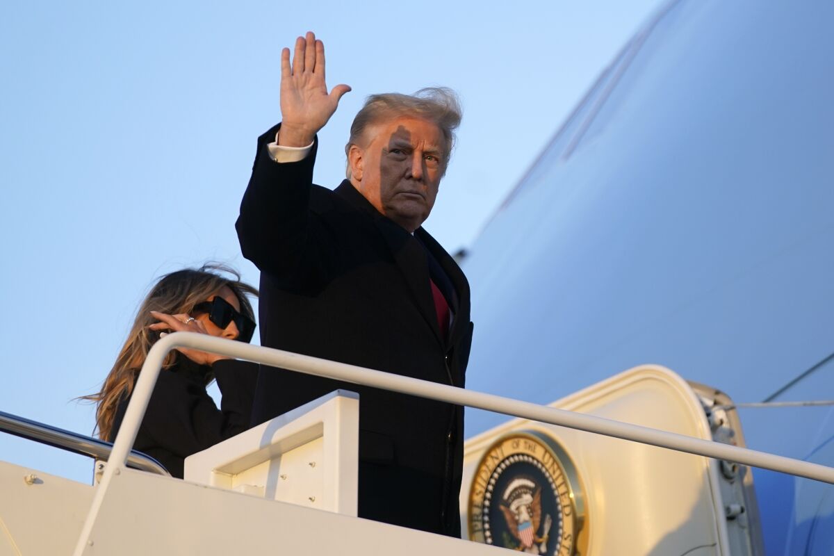 President Trump waves and boards Air Force One