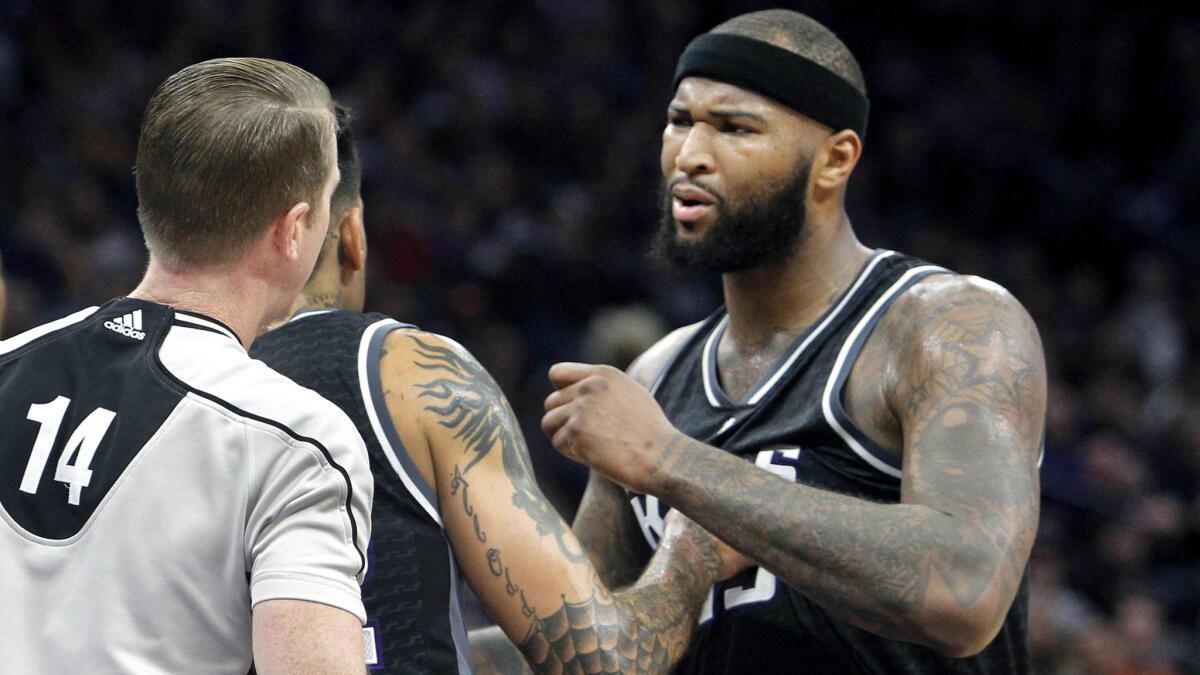 Sacramento Kings center DeMarcus Cousins is held back by teammate Matt Barnes during an argument with official Ed Malloy over a foul called against him during the second half of a game against the Memphis Grizzlies this season.