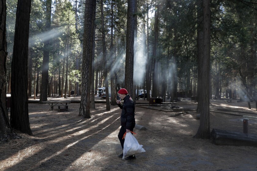 Seth Williams from Costa Mesa carries his garbage to a trash can in Upper Pines Campground inside Yosemite National Park