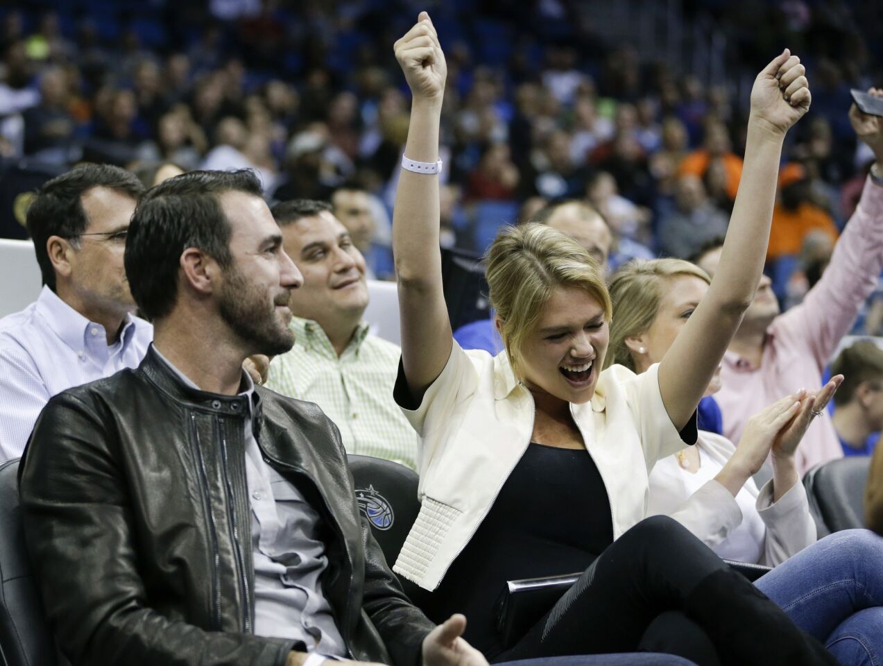 Detroit Tigers pitcher Justin Verlander and model Kate Upton cheer during the first half of an NBA game between the Orlando Magic and the Oklahoma City Thunder in Orlando, Fla.