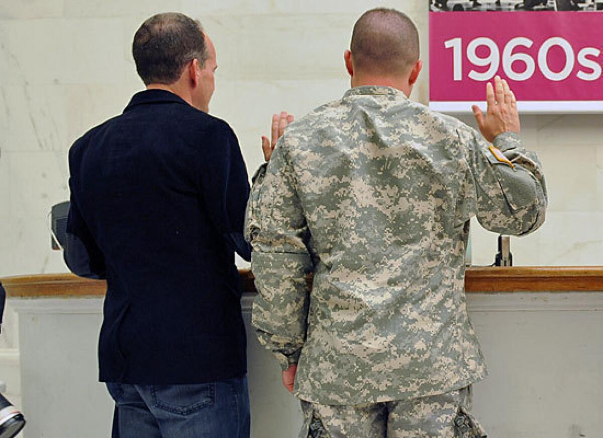 A soldier and his partner get married in June at San Francisco City Hall. The Obama administration will allow same-sex spouses to get federal veterans' benefits.