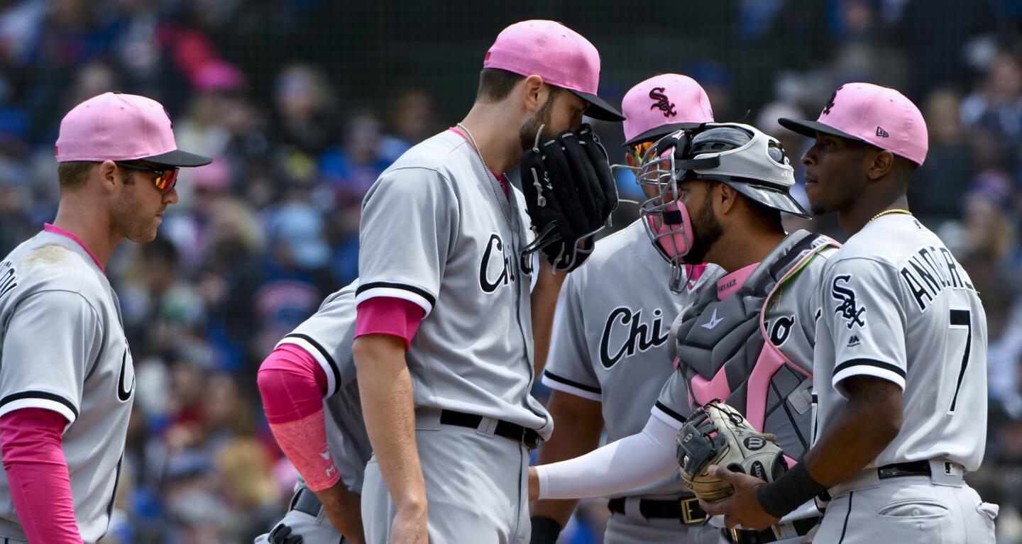 White Sox starter Lucas Giolito, center, talks with teammates during the first inning against the Cubs at Wrigley Field on Sunday, May 13, 2018.