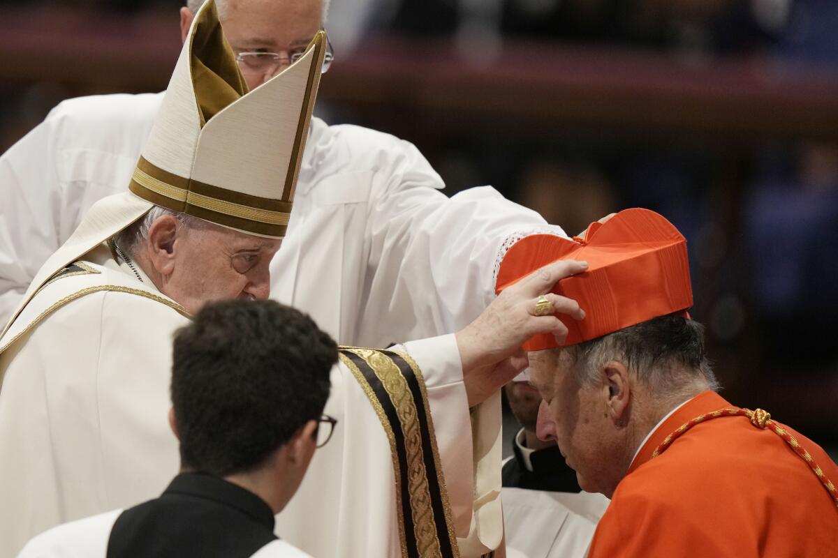 New Cardinal Giorgio Marengo receives the red three-cornered biretta hat  from Pope Francis during a consistory inside St. Peter's Basilica, at the  Vatican, Saturday, Aug. 27, 2022. Pope Francis has chosen 20