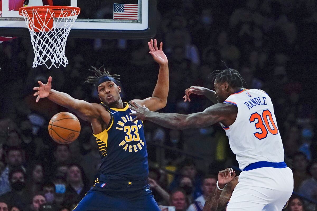 New York Knicks' Julius Randle (30) passes away from Indiana Pacers' Myles Turner (33) during the first half of an NBA basketball game Tuesday, Jan. 4, 2022, in New York. (AP Photo/Frank Franklin II)