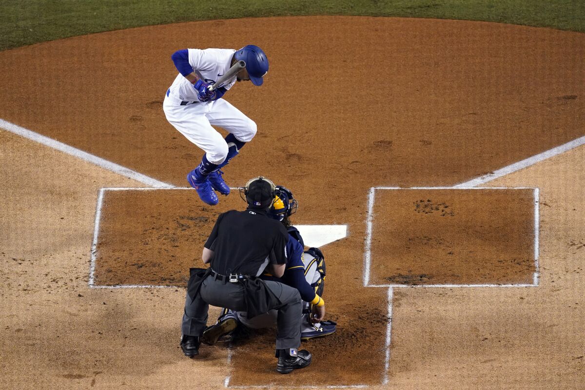 Dodgers leadoff batter Mookie Betts jumps to avoid being hit by a pitch during the first inning of Game 2.