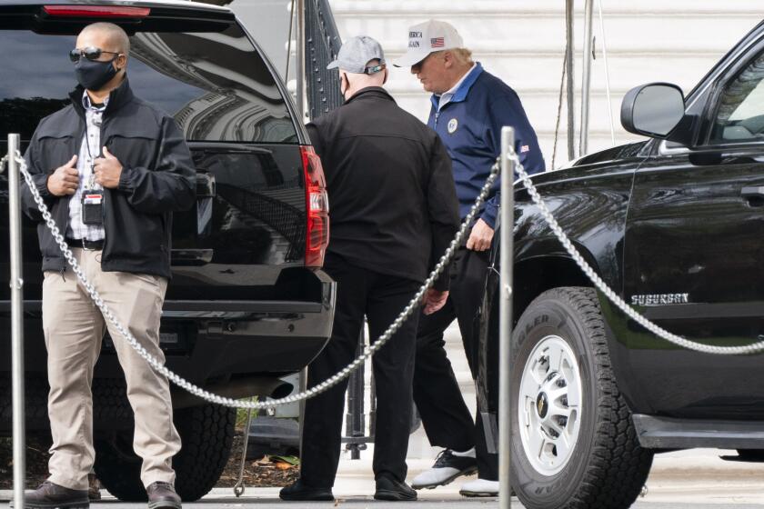 President Donald Trump, right, walks to the motorcade, Sunday, Nov. 22, 2020, as he departs the White House in Washington. (AP Photo/Jacquelyn Martin)