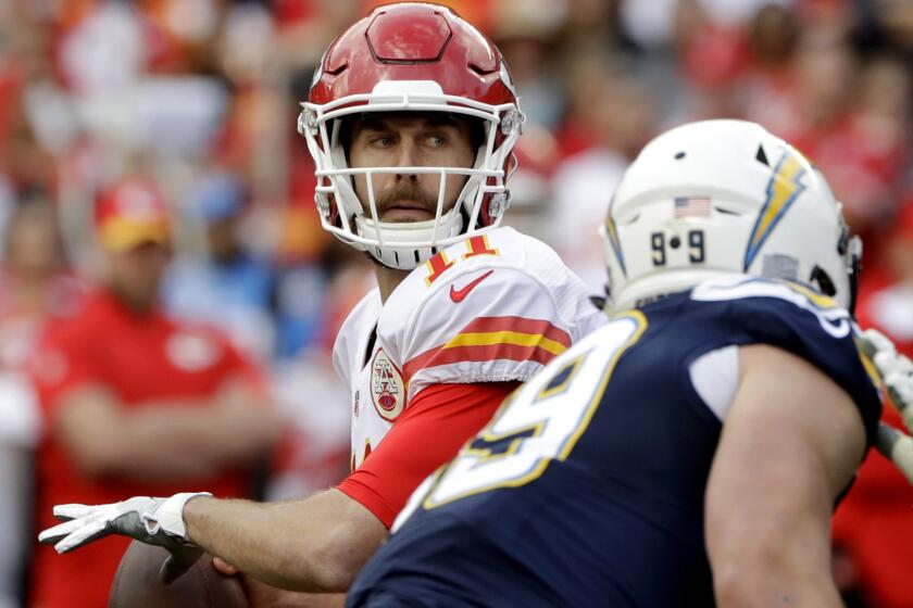 Chiefs quarterback Alex Smith looks to pass against the Chargers during the first half Sunday.
