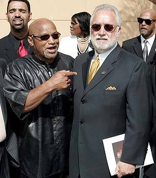 Elmer "Geronimo" Pratt, left, arrives with Danny Bakewell, of the Brotherhood Crusade of Los Angeles, for Johnnie Cochran's funeral.
