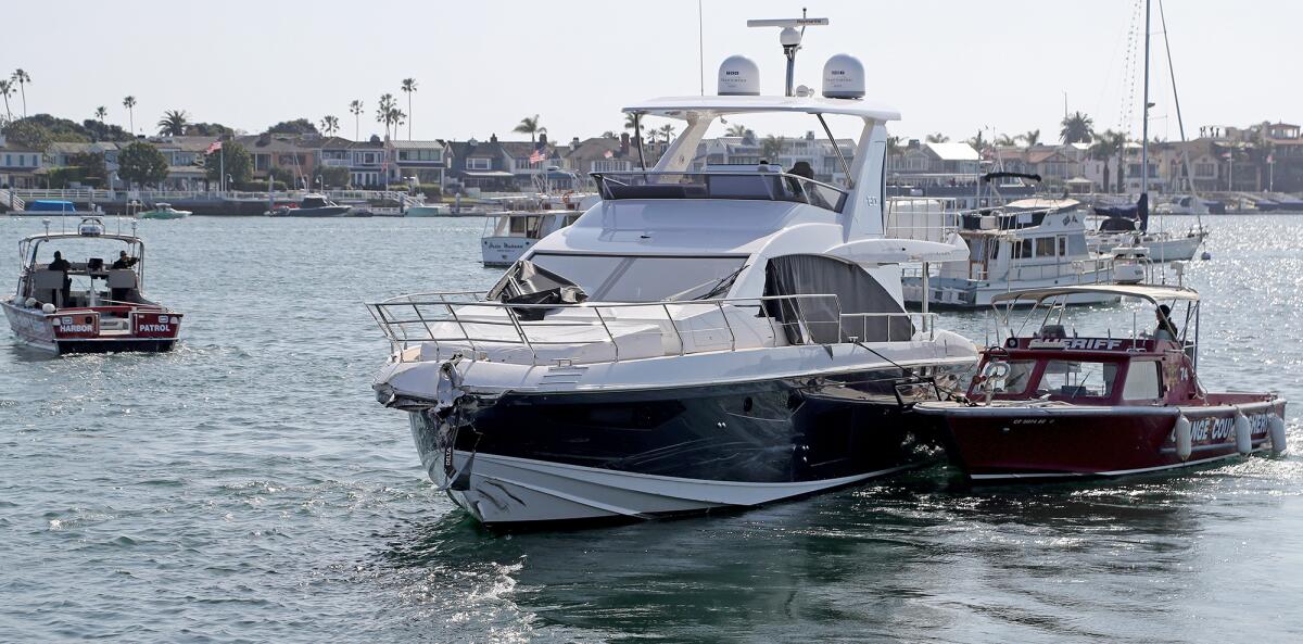 A stolen yacht that crashed into other boats in Newport Harbor is removed from the dock at the OCSD's Harbor Patrol Yard.
