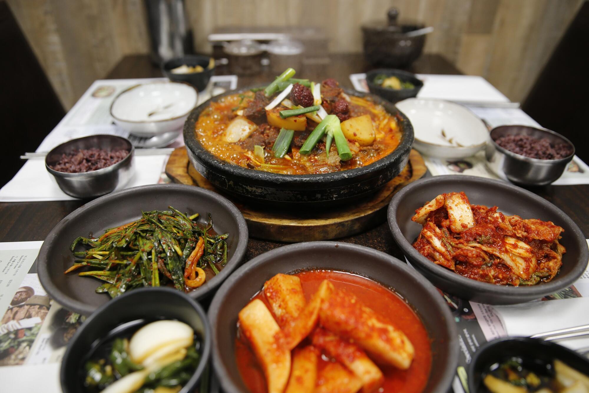 several dishes of food on a table in Koreatown, Los Angeles