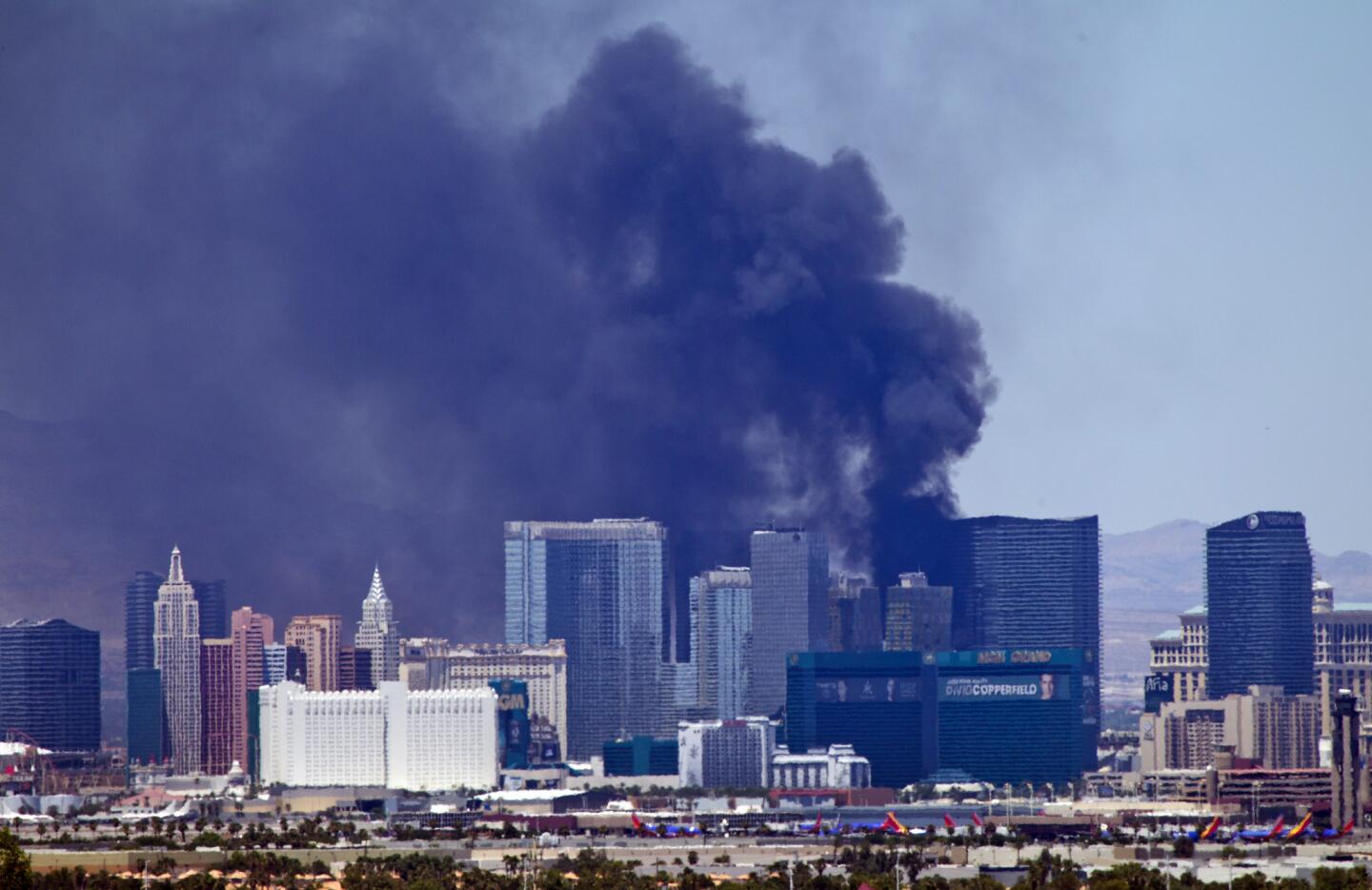 Smoke billows from a fire Saturday on the outside pool area of the Cosmopolitan of Las Vegas hotel-casino in Las Vegas.