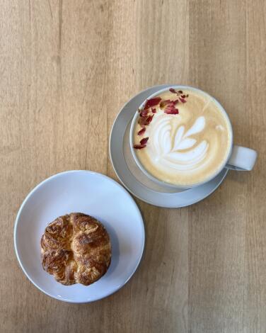 A cup of coffee and pastry at Theory Coffee Roasters.