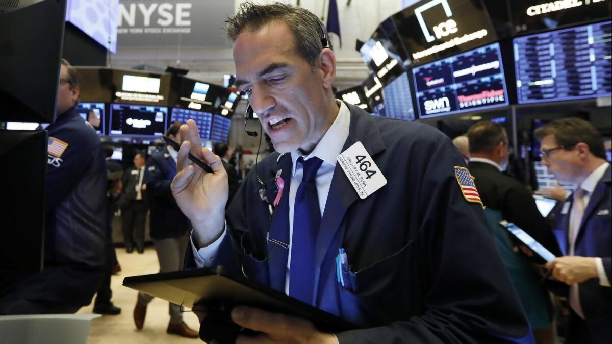 Trader Gregory Rowe works on the floor of the New York Stock Exchange on Tuesday.