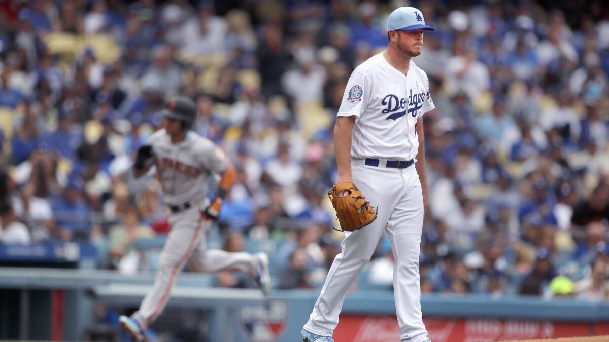 Dodgers pitcher Caleb Ferguson looks away as Giants Gorkys Hernandez heads to home plate on Brandon Belt's two-run home run in the third inning.