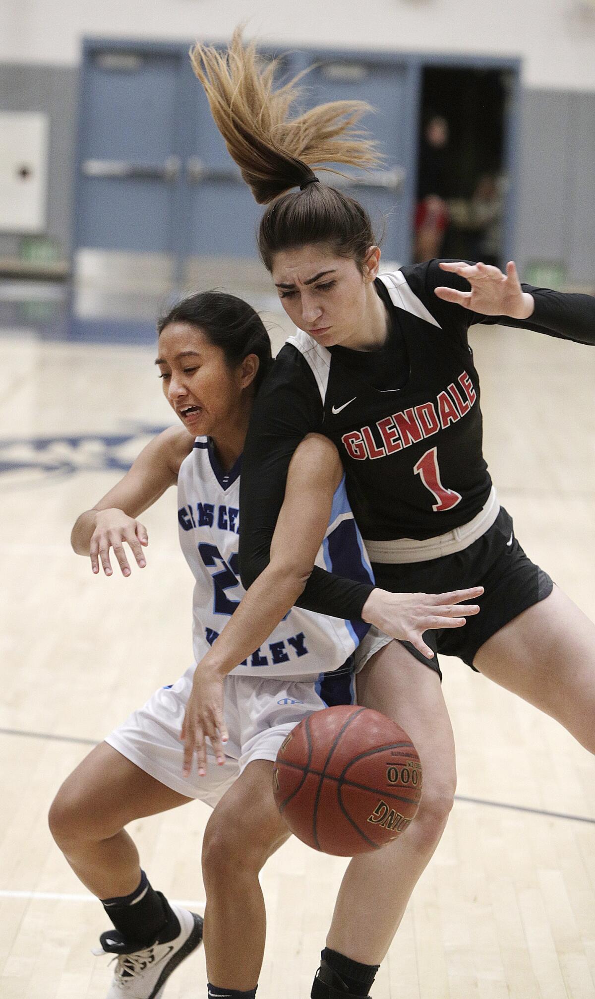 Crescenta Valley's Denise Dayag and Glendale's Mary Markaryan battle for a loose ball after a shot in a Pacific League girls' basketball game at Crescenta Valley High School on Tuesday, January 7, 2020.