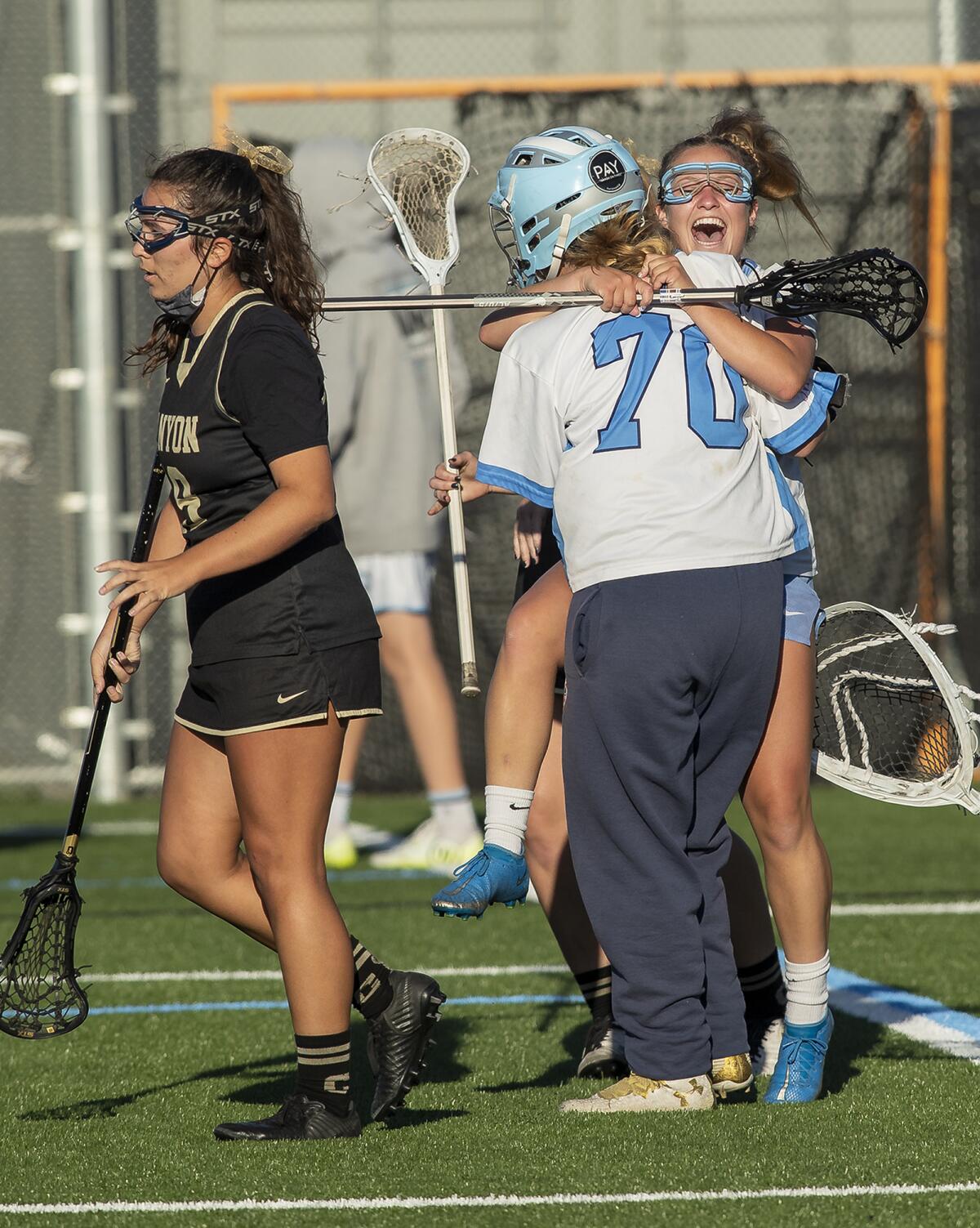 Corona del Mar's Kate Kittleson hugs Ellie Spotts (70) after beating Canyon in the CIF Southern Section Division 2 final.