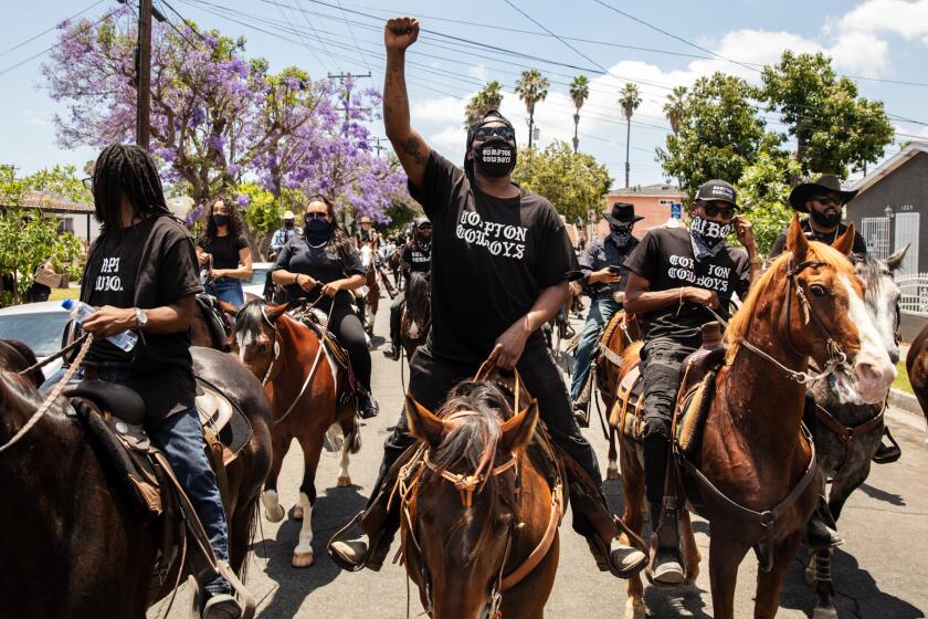 COMPTON, CA - JUNE 07: The Compton Cowboys ride down S Tamarind Ave, along with a couple thousand protesters, during the Compton, CA, Peace Ride, culminating at City Hall, on Sunday, June 7, 2020. (Jay L. Clendenin / Los Angeles Times)