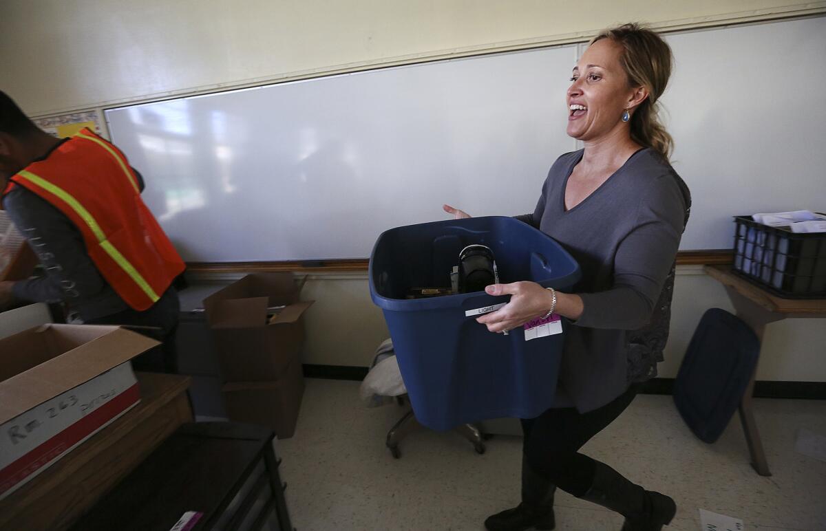 Science teacher Rosie Van Zyl organizes her new classroom at Northridge Middle School.