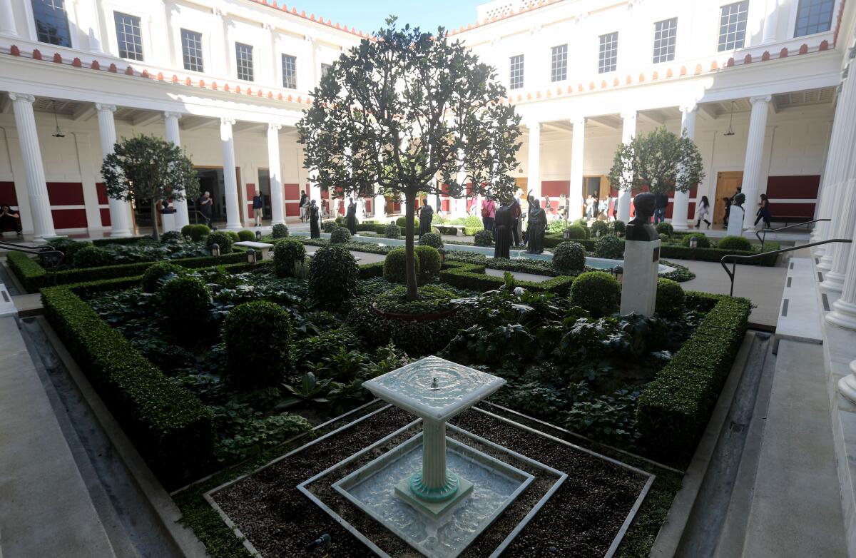 People walk along the courtyard at the Getty Villa in Pacific Palisades.