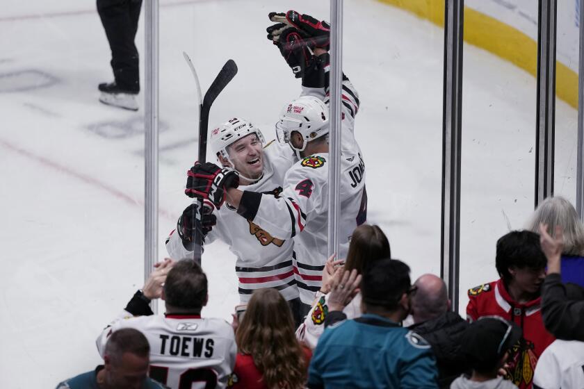 Chicago Blackhawks defenseman Seth Jones, right, is congratulated by center Philipp Kurashev after scoring against the San Jose Sharks in overtime of an NHL hockey game in San Jose, Calif., Saturday, March 23, 2024. (AP Photo/Jeff Chiu)