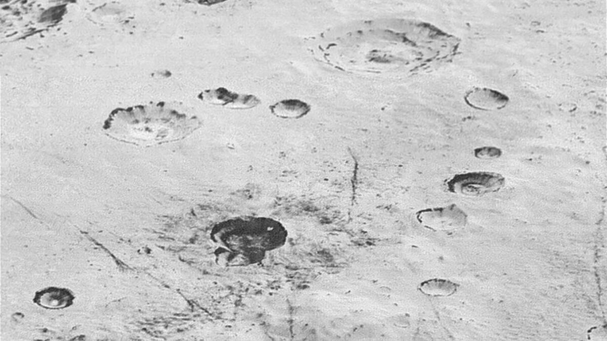 A high-resolution image of craters on Pluto's icy plains gives scientists a glimpse beneath the dwarf planet's surface.