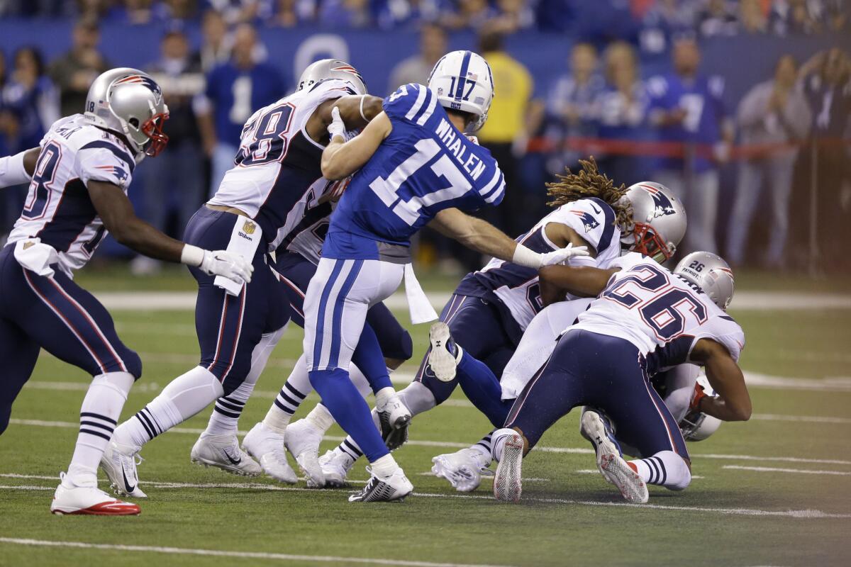 Indianapolis' Griff Whalen can do nothing to prevent teammate Colt Anderson from being tackled by a group of New England Patriots on Sunday.