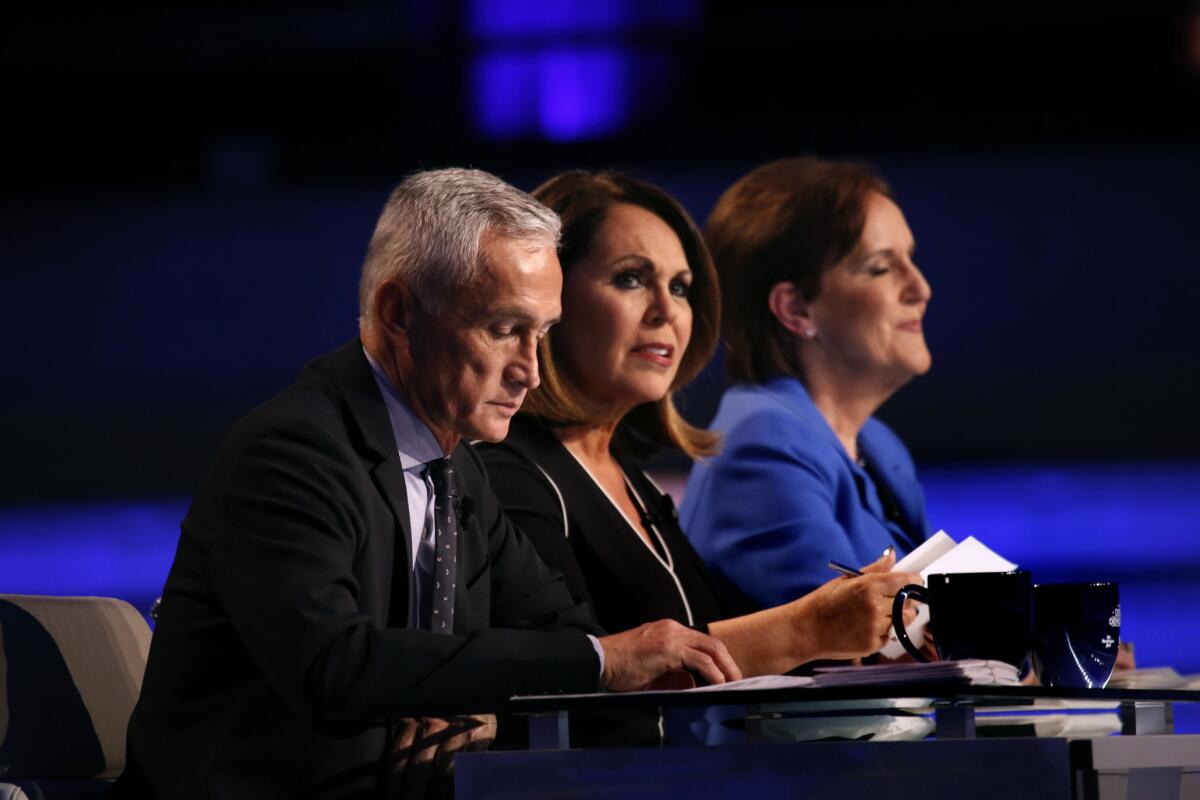 AT&T and Univision declared a truce in a carriage fee dispute to allow Spanish-language customers of U-Verse to watch Univision's Democratic presidential debate in Miami. Pictured are the debate moderators, Univision co-anchors Jorge Ramos, left, and Maria Elena Salinas, and Karen Tumulty of the Washington Post, which co-sponsored the debate.