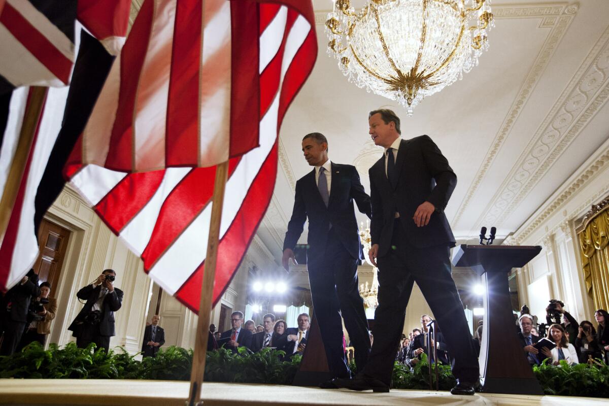 President Obama and British Prime Minister David Cameron leave after a news conference in the East Room of the White House.