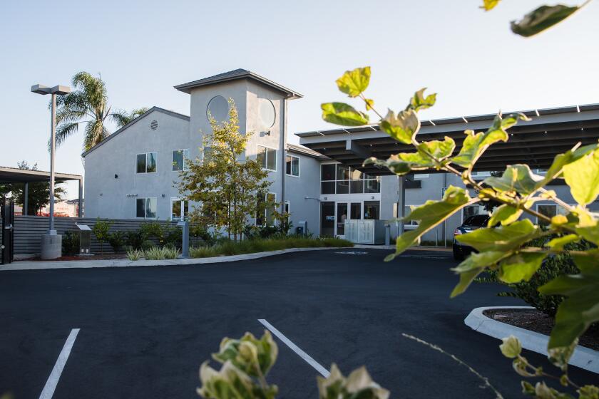 The exterior of an interim family shelter that was once a Super 8 Motel in South Bay on July 27, 2020. The shelter has a shared kitchen, laundry facilities, a garden and an outdoor area for meditation.