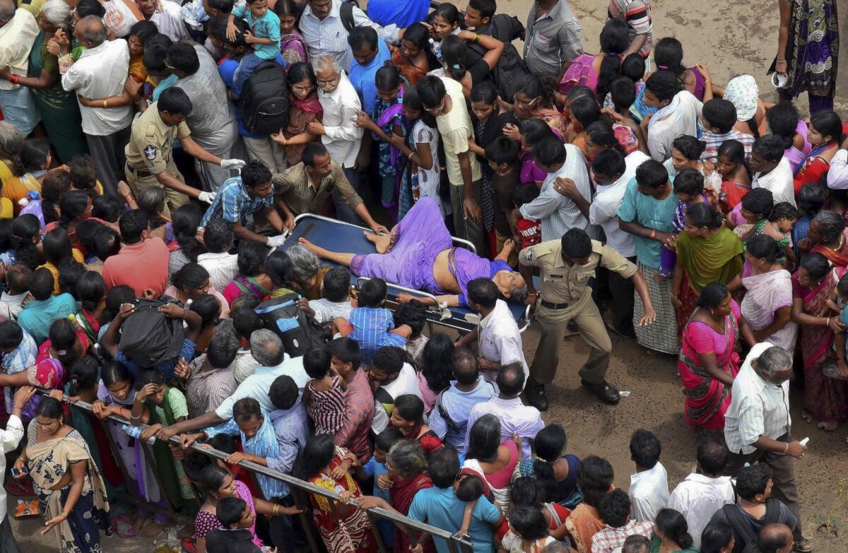 A woman is rushed to a hospital on a stretcher after a stampede during a religious festival on the bank of the Godavari River in Rajahmundry, India, on July 14.