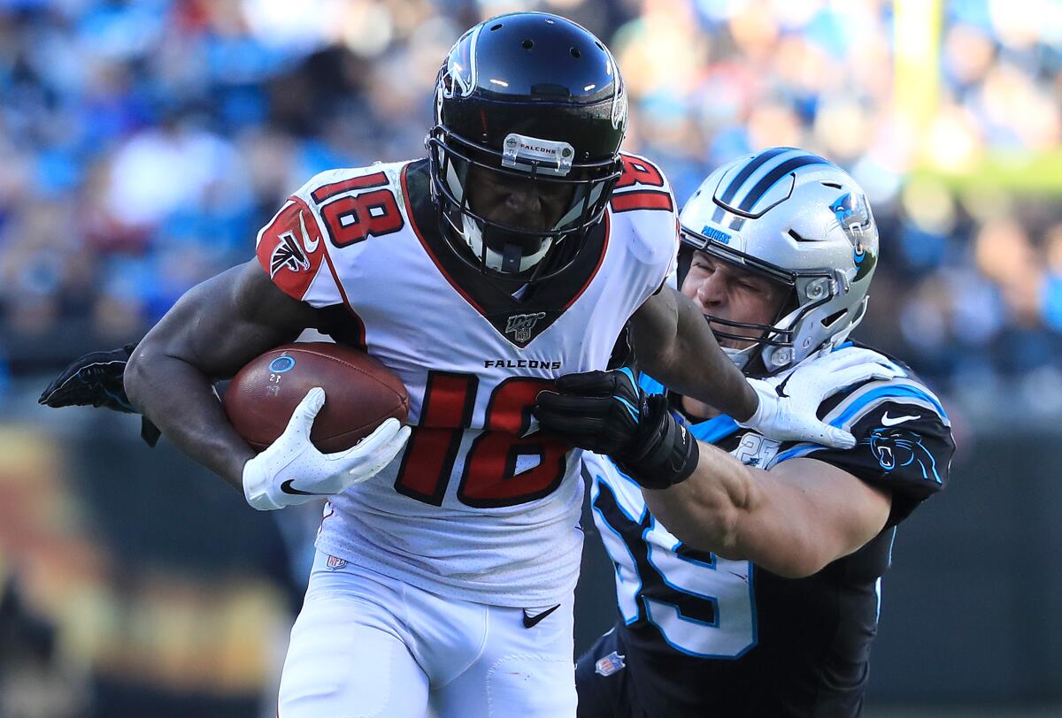 Falcons receiver Calvin Ridley is tackled by Panthers linebacker Luke Kuechly during a game Nov. 17 at Bank of America Stadium.