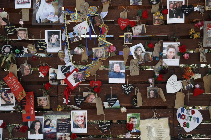 Photos and notes adorn a wall at the Las Vegas Community Healing Garden in Las Vegas on Oct. 16, 2017. Two judges have ordered the release of search warrant records and autopsy reports related to the deadliest mass shooting in modern U.S. history, with some information redacted.