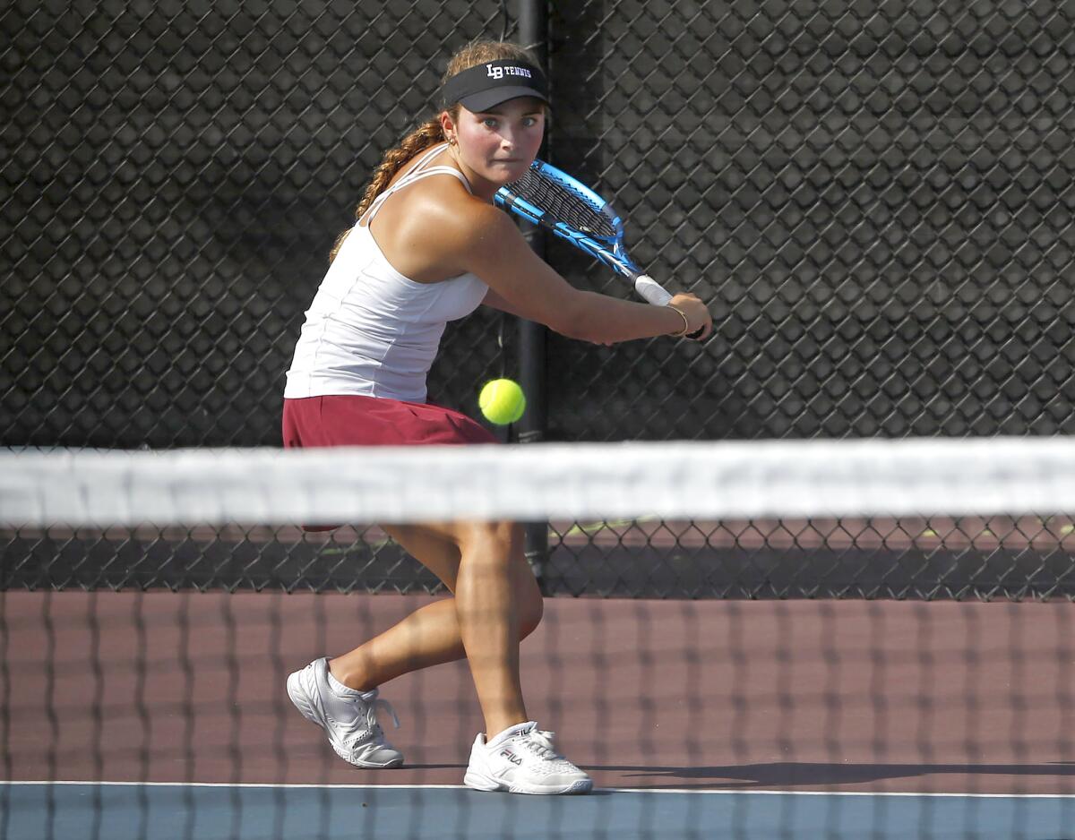 Laguna Beach singles player Rebecca MacCallum hits a backhand in her match against Corona del Mar on Thursday.