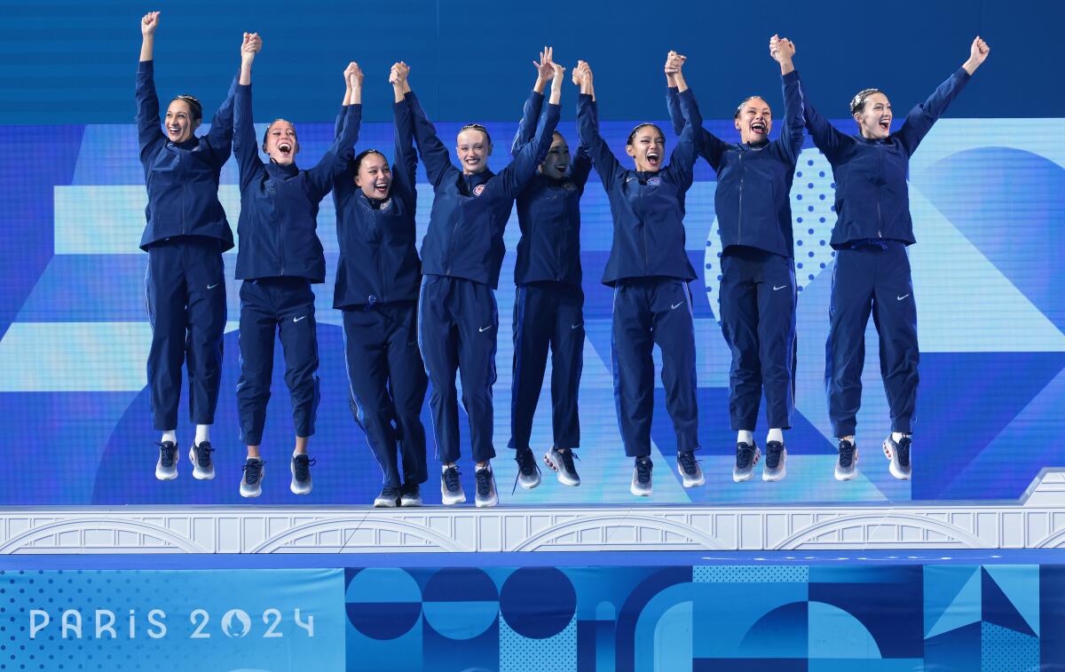 Team USA celebrates the silver medal during the artistic swimming competition.