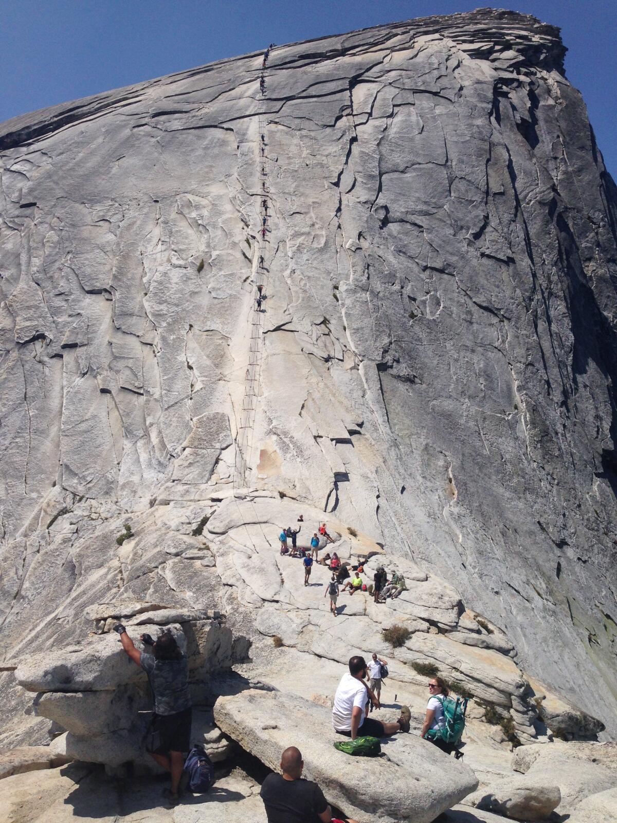 A 2015 view of hikers resting before taking on the last 400 feet of cables that lead to the top of Yosemite's Half Dome.