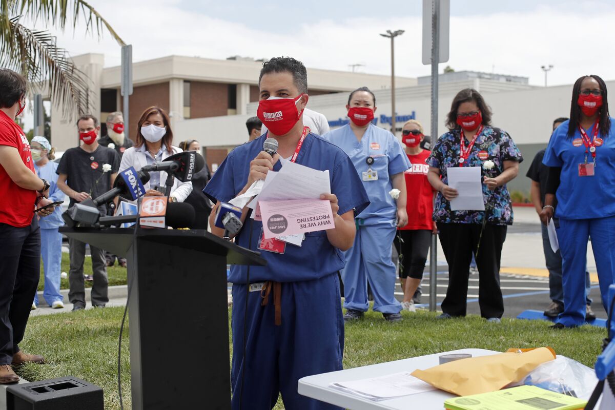 Josh Jesus, a CT Tech, speaks during a press conference outside Fountain Valley Regional Hospital's emergency room Thursday.