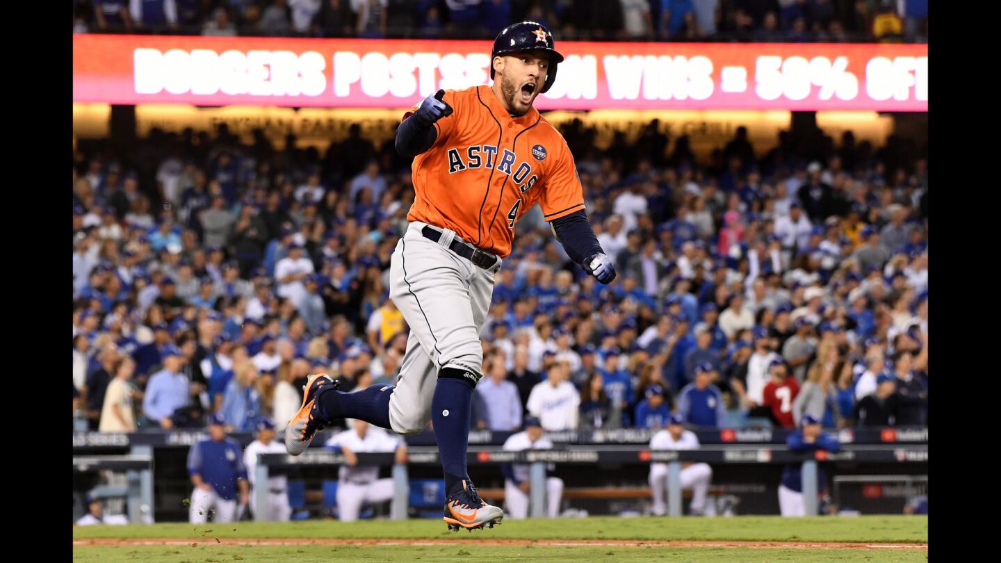 The Astros' George Springer runs the bases after hitting a two-run home run against Dodgers pitcher Yu Darvish in the second inning.