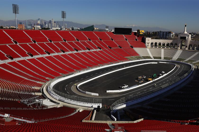 LOS ANGELES-CA-JANUARY 24, 2022: Lane lines are painted ahead of the NASCAR race at the L.A. Memorial Coliseum on Monday, January 24, 2022. (Christina House / Los Angeles Times)