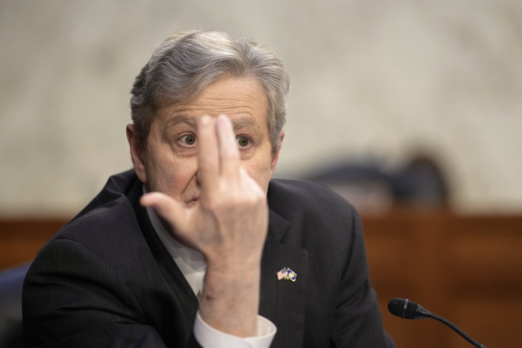 John Kennedy gestures while speaking 