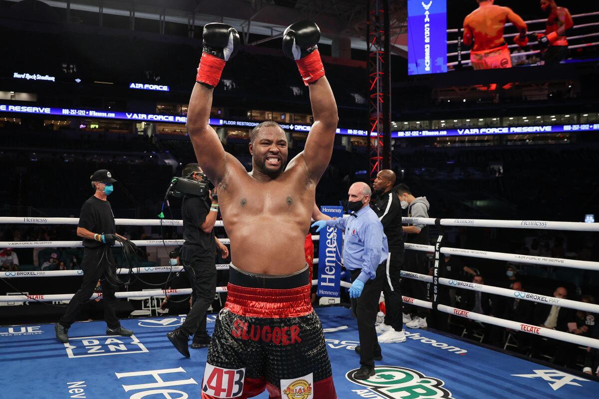 Jerry Forrest celebrates after his split decision against Zhilei Zhang in a heavyweight fight.