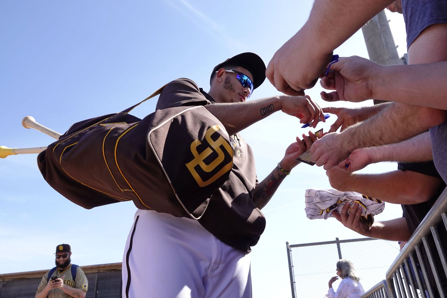 San Diego Padres Manny Machado signs autographs for after a Padres spring training practice on Feb. 18, 2020.