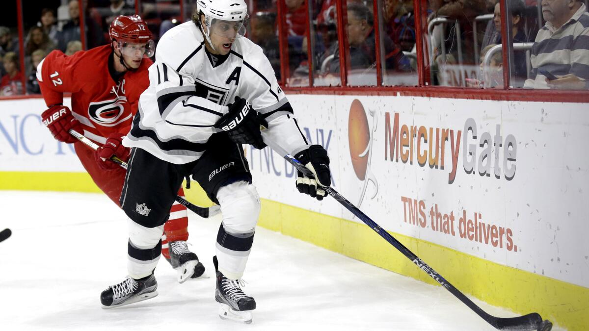 Kings center Anze Kopitar collects a loose puck along the board during a game against the Hurricanes on Nov. 22.