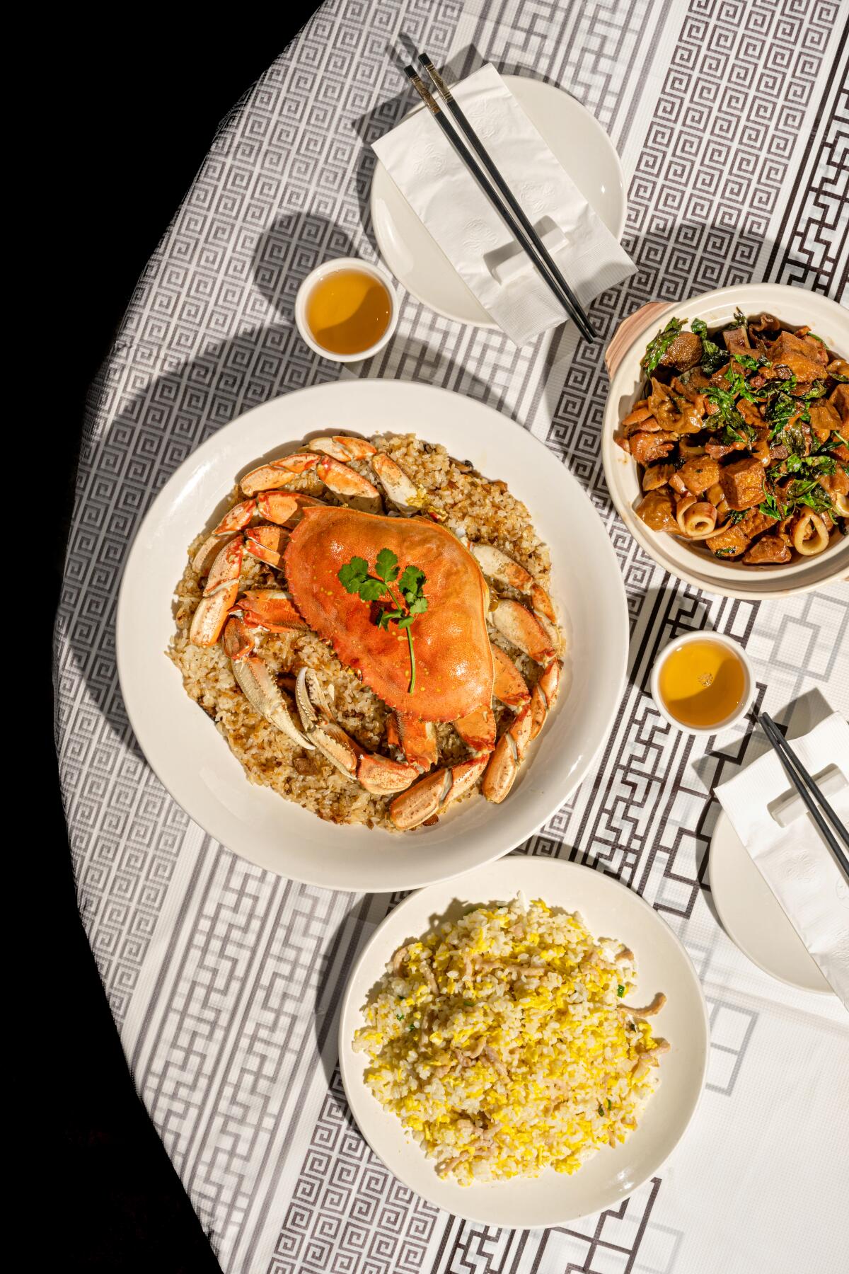 An overhead vertical photo of dungeness crab; tofu casserole; and fried rice from Eat Joy Food in Rowland Heights Los Angeles